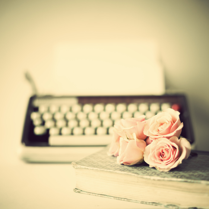 Vintage typewriter and roses over book